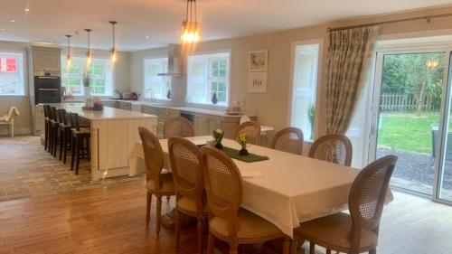 a dining room and kitchen with a table and chairs at Lacken Millhouse and Gardens in Cavan