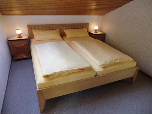 um quarto com uma cama grande e 2 mesas de cabeceira em Ferienwohnung Holl em Berchtesgaden