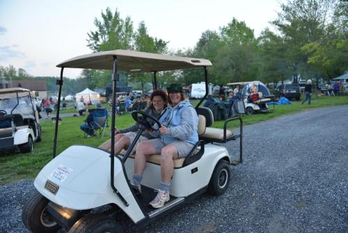 a man and woman sitting on a golf cart at Spring Gulch Chalet 12 in Mount Airy