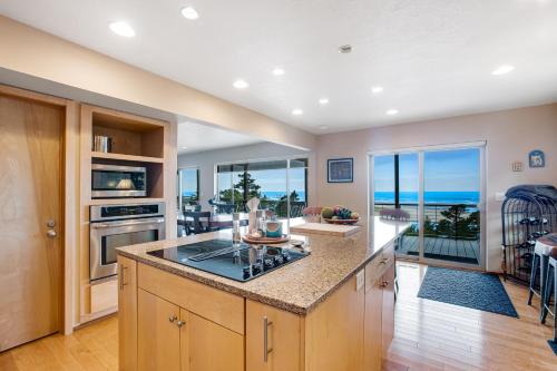 a kitchen with a counter and a view of the ocean at Top of the World in Tillamook