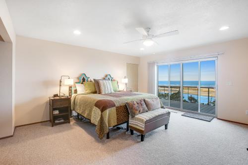 a bedroom with a bed and a view of the ocean at Top of the World in Tillamook