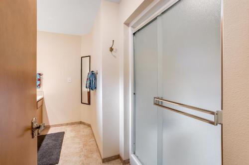 a bathroom with a glass door and a hallway at Top of the World in Tillamook