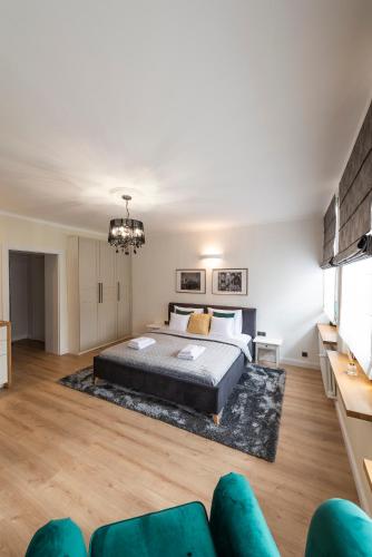 a bedroom with a bed and a couch at Balans Studio Old Town in Gdańsk