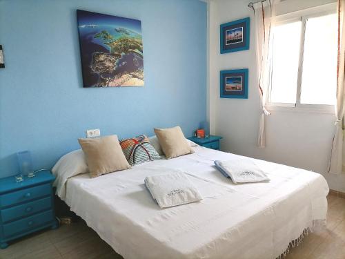 a bedroom with a bed with two pillows on it at Vera Sol y Mar - Naturist Zone in Playas de Vera