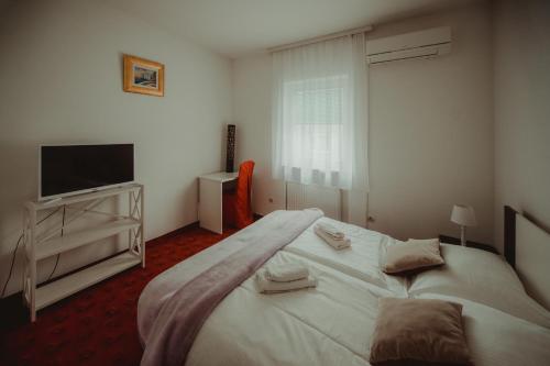 Ένα ή περισσότερα κρεβάτια σε δωμάτιο στο B&B Laguna