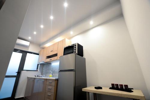 a small kitchen with a refrigerator and a table at CENTRO PATRAS in Patra