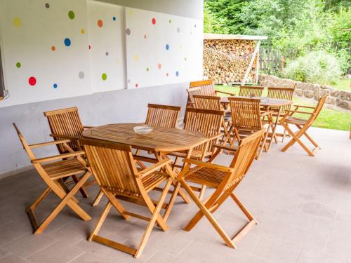 a group of wooden tables and chairs on a patio at Penzion U Cempu in Kunratice
