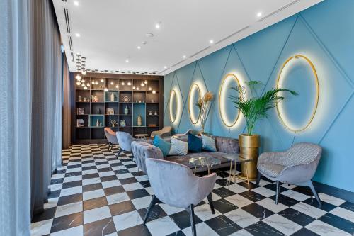 a lobby with a couch and chairs and mirrors at Taberne Boutique Hotel Tbilisi in Tbilisi City