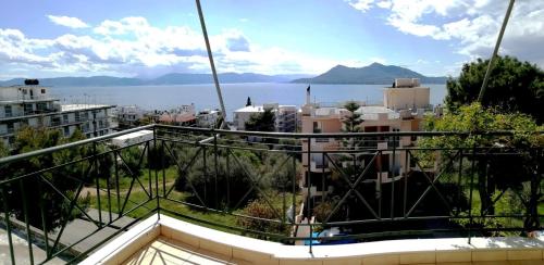a balcony with a view of the water and buildings at Nefeli Studios in Loutra Edipsou