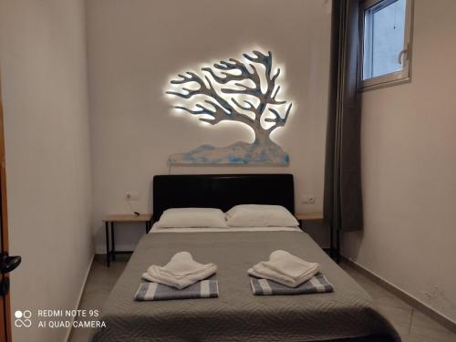 a bedroom with a bed with two towels on it at Despina garden view in Agia Galini