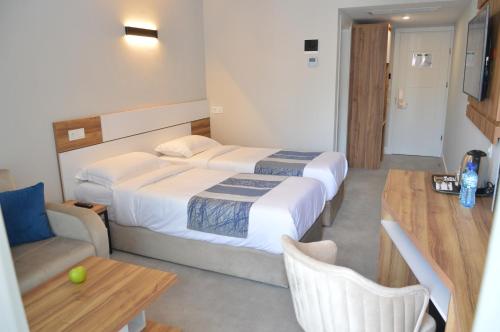 a hotel room with two beds and a table at Old Batumi Hotel in Batumi