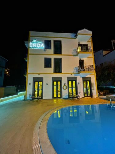 a hotel with a swimming pool in front of a building at Enda Boutique Hotel Kalkan in Kalkan