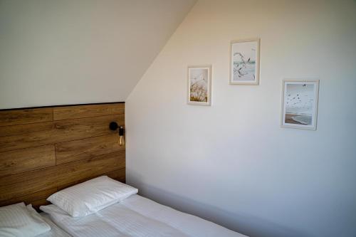 a bedroom with a bed and three pictures on the wall at Dream-House in Kopalino