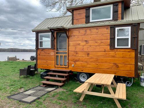 a tiny house on a trailer with a bench at Shady Haven - Tiny Home 1 in Bellevue