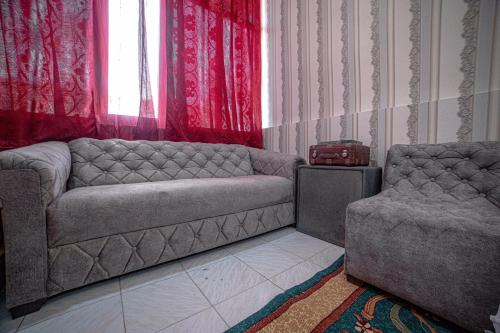 a living room with a couch and a chair at HOSTEL NABI BOBO in Samarkand
