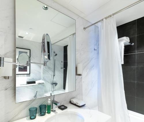 a bathroom with a shower and a sink and a mirror at Luxury residence at Dubai Mall in Dubai