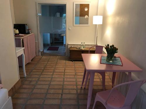 ein Wohnzimmer mit einem Tisch und Stühlen sowie eine Küche in der Unterkunft Der Birkenhof - Birch Court in Düsseldorf
