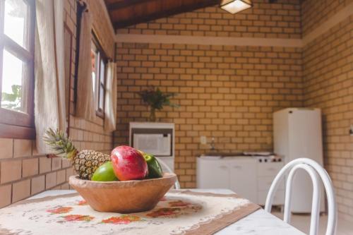 a bowl of fruit on a table in a kitchen at Hospedaria Nativa in Praia do Rosa