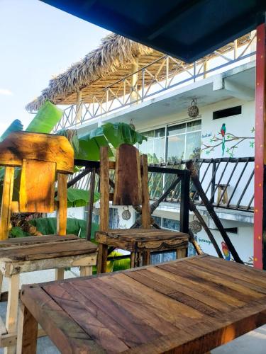 a wooden table and two chairs in a room at La Casa de las Aves in Bacalar