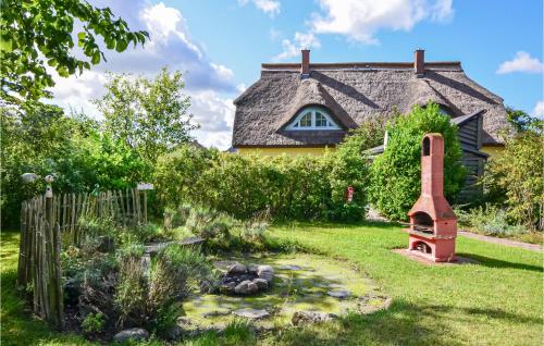 a garden in front of a house with a fireplace at Haus 1C in Vieregge