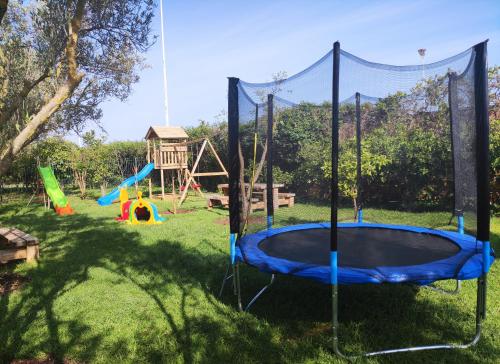 a playground with a trampoline in the grass at Equi Palace & SPA Near Aeroport in Berrechid
