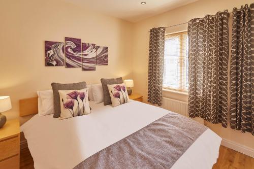 a bedroom with a bed with two pillows and a window at Host & Stay - The Scuttlebutt Townhouse in Whitby