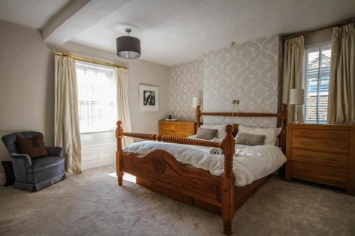 a bedroom with a bed and a chair and a window at Bay Horse House in Easingwold