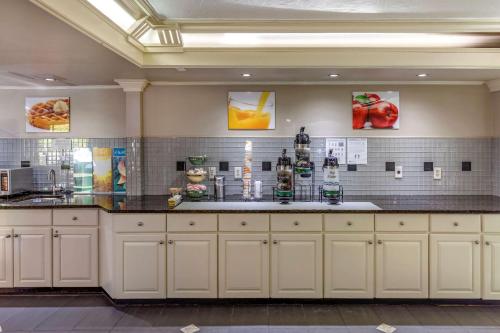 a large kitchen with white cabinets and a counter at Quality Inn Duluth - Atlanta Northeast in Duluth