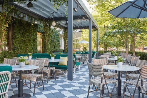 an outdoor seating area with tables and chairs at The Dupont Circle Hotel in Washington