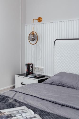 a bedroom with a bed and a desk with a lamp at NEW! Luxury apartment in the CENTER of ODESSA overlooking Deribasovskaya str. LOW PRICE! in Odesa