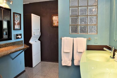 a bathroom with a sink and a refrigerator at The Kern Lodge in Kernville