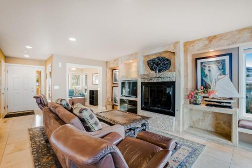 a living room with a couch and a fireplace at Surf and Sand in Lincoln City