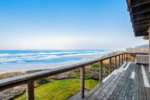 a view of the beach from the balcony of a house at Surf and Sand in Lincoln City