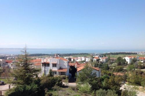 a city with houses and the ocean in the background at Τraditional fully detached villa on a luxurious hillock of Thessaloniki with its own garden also for family & wedding gatherings for 10 to 25 people only 15 minutes from airport in Thessaloniki