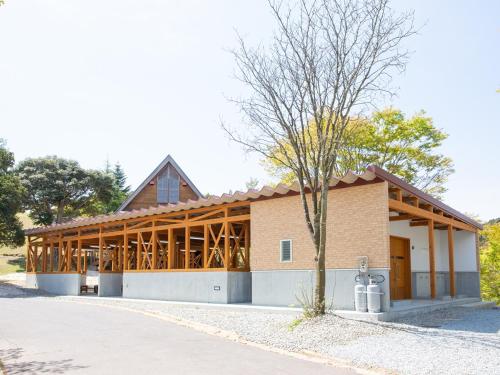 a large brick building with a tree in front of it at Matsue Forest Park in Matsue