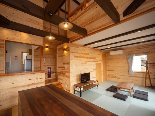 a room with wooden walls and a large wooden table at Matsue Forest Park in Matsue