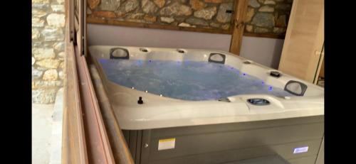 a bath tub in a bathroom with at Petrines Villes Avramilias in Avramiliá