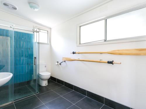 a bathroom with a glass shower and a toilet at Summer In Blairgowrie in Blairgowrie
