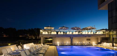 a hotel with a swimming pool and lounge chairs at Nest Hotel Incheon in Incheon