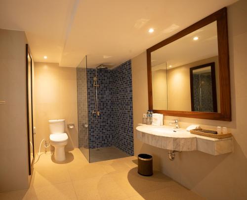 a bathroom with a toilet and a sink and a shower at New Sunari Lovina Beach Resort in Lovina