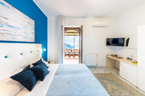 a bedroom with a large bed with blue walls at A Due Passi in Ravello