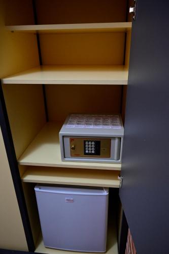 a microwave sitting on a shelf in a closet at Hotel Marina in Marina di Massa