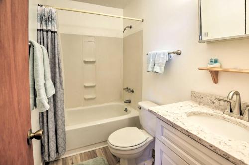 a bathroom with a tub and a toilet and a sink at Renovated Crescent Lake Escape with Waterfront Deck! in Crescent City