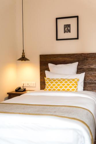 a bedroom with a large bed with yellow and white pillows at Hotel Roadhouse, Thamel, Kathmandu- Contemporary Boutique in Kathmandu