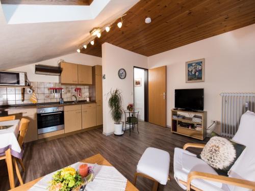a large living room with a table and a kitchen at Ferienwohnung Tichy in Berchtesgaden