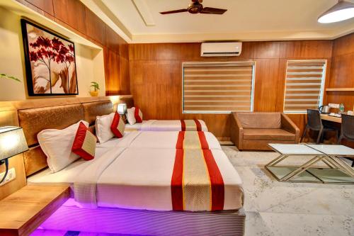 a bedroom with two beds in a room at FabHotel Nestlay Rooms Airport in Chennai