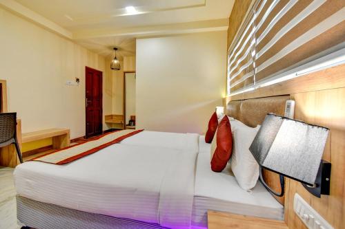 a bedroom with a large bed in a room at FabHotel Nestlay Rooms Airport - Nr Chennai International Airport in Chennai