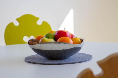 a bowl of fruit sitting on a table at Residence Villa Schlern in Fiè