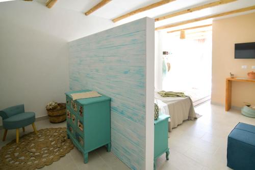 a room with a blue accent wall and a bedroom at LUCCICAMARE family-run BeB in Noto