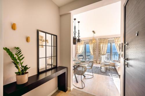 a living room with a table and chairs and a mirror at 2MONTENEGRO LIMETA APARTMENTS with pool in Kotor